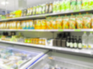 Defocused image of large Supermarket background. Retail industry. Blur rack. Shopping. Aisle. Grocery. Shelves with products. CPG. Rise price. Inflation. Chain store. Merchandise. Delivering food.