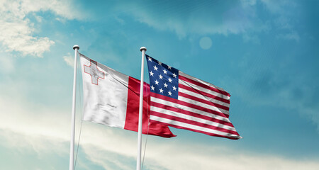 Malta and America friendship flags are waving in the sky.Two country flag for agreement or deal. Malta USA national flag for comittment.