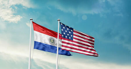 Paraguay and America friendship flags are waving in the sky.Two country flag for agreement or deal. Paraguay USA national flag for comittment.