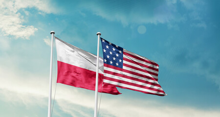 Poland and America friendship flags are waving in the sky.Two country flag for agreement or deal....