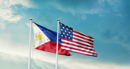 Philippines and America friendship flags are waving in the sky.Two country flag for agreement or...