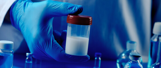 man holding a container with semen, banner