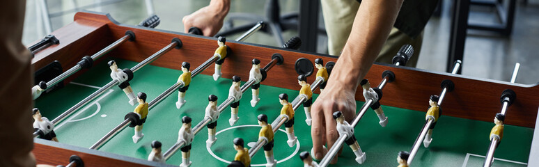 Engaging in a spirited foosball match to foster team spirit and collaboration in a modern office