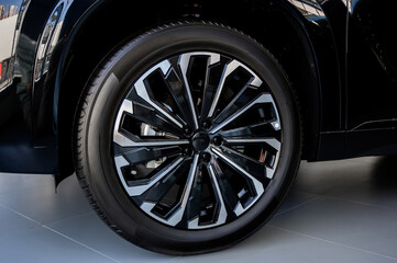 Car wheel with brake calipers and stylish design.