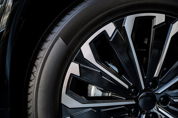 Car wheel with brake calipers and stylish design.