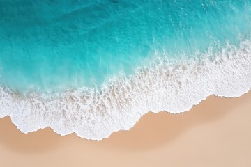 Aerial view of turquoise ocean waves gently washing onto a sandy beach.
