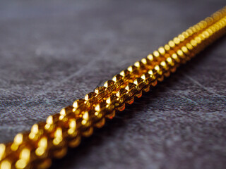 gold necklace, gold price, gold jewelry, close up of gold necklace on grey background