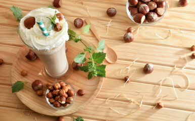Background with freshly made hazelnut drink on a rustic table