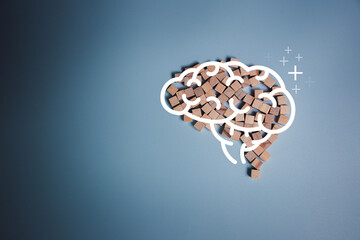 Concept of creativity and intelligence. Brain icon on wooden blocks arranged in the shape of a brain on a blue background in top view. Brain Nervous System concept. human brain, thinking concept.  