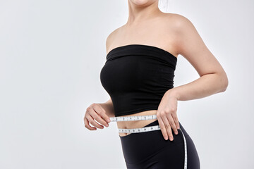 Female Measuring Waist with Tape Measure