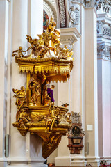 Interior of St. Stephans cathedral in Passau, Germany is an old white church with famous organ pipes