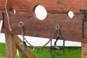 Rustic wooden stockade with metal shackles for historical medieval reenactment