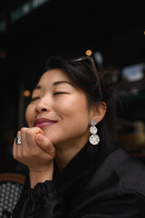 Close-up portrait of young Asian woman with natural expression. Beautiful skin, serene look,...