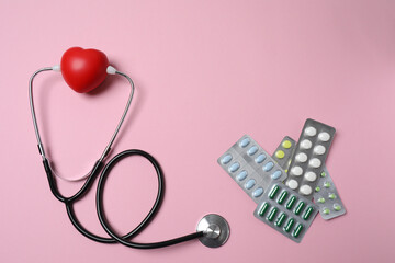 stethoscope, large pile of multi-colored pills in blister pack disposable , close-up, side view