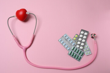 stethoscope, large pile of multi-colored pills in blister pack disposable , close-up, side view