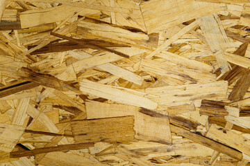 OSB board texture closeup suitable for construction, renovation and interior design projects. Wooden surface background for eco-friendly and sustainable materials