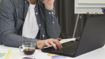 Focused businessman engaged in a phone conversation at his office desk
