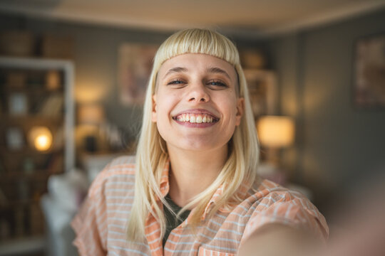 Young beautiful woman do selfie picture at home smile happy