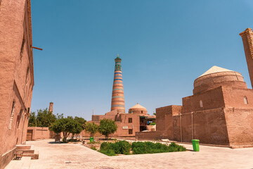 A courtyard with a tall building in the background