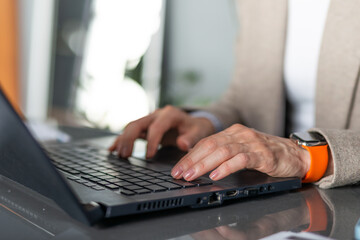 Female hands on a laptop keyboard works