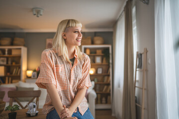 Portrait of young blonde woman at home happy positive