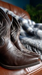 Brown leather cowboy boots on a couch