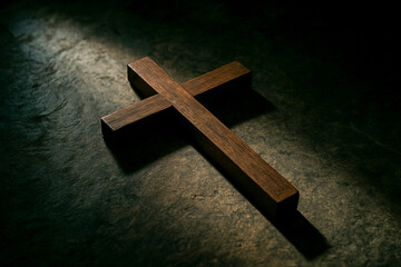 Wooden Cross Lying on Stone Floor in Dramatic Lighting