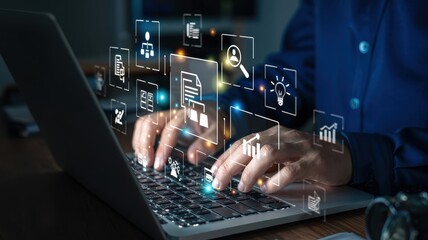 Person working on laptop with digital interface overlay.