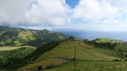 Fototapeta premium Miradouro Pico da Casinha - This viewpoint offers fantastic views over the green hills of Ribeira dos Barqueiros 