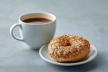 A freshly brewed coffee paired with a seeded bagel on a plate.
