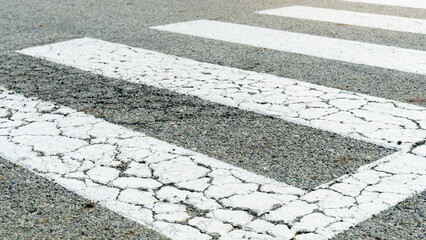 Color of zebra crossing or crosswalk for crossing the road is white. Asphalt road surface with...