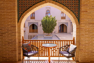 A balcony with two chairs and a table