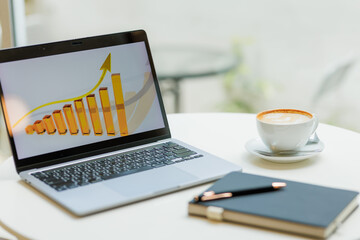 Two professionals discussing business growth and digital marketing strategy using graphs and...