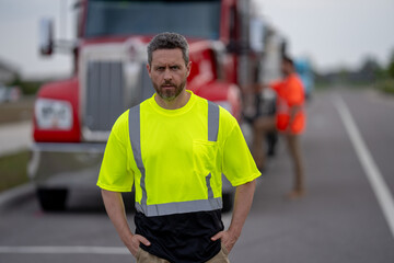 Happy confident male driver standing in front on his truck looking at camera. Portrait of happy...