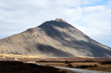 View of mountain peak with shadows formed by clouds in the Hvalfjar&eth;arsveit of Western Iceland