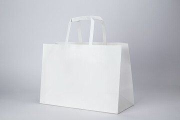 White paper bag with handle isolated on white background
