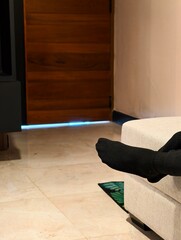 Cozy Living Space with a Foot Resting on a Sofa Edge