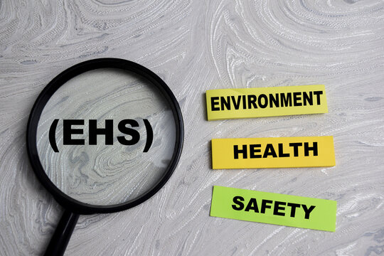 Concept of EHS - Environment Health Safety write on sticky notes isolated on Wooden Table.