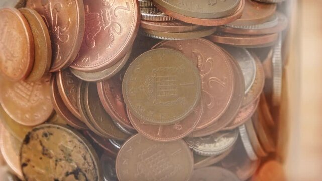 UK pennies in a jam jar savings close up stock footage