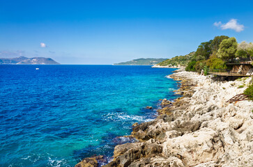 Rocky coastline in Kaş (also spelled Kas or Kash), Turkey (Türkiye), with stunning clear blue...