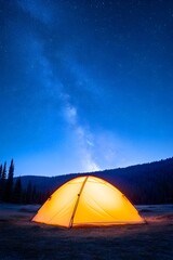 Illuminated dome tent glows under a vibrant night sky, showcasing the Milky Way galaxy above a dark mountain range