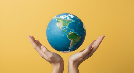 Hands Holding Earth Globe Against Warm Yellow Background