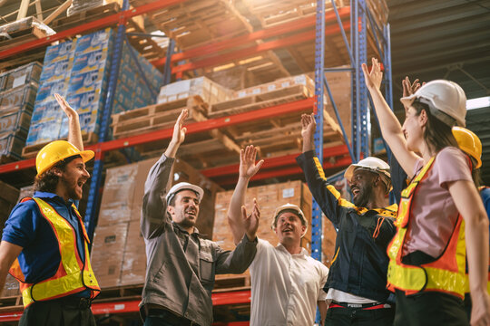 Group of worker in warehouse team cheerful together in inventory cargo building for teamwork people