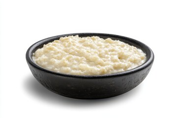 Creamy bowl of porridge served in a rustic black dish, with a soft, inviting texture