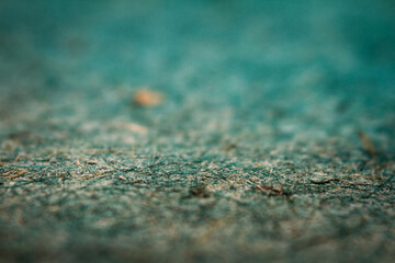 Extreme closeup of turquoise handmade paper with shallow depth of field.
