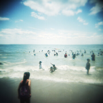 Tourists enjoying the beach at Coney Island, Brooklyn, New York City, United States
