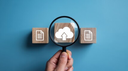 Magnified cloud upload symbol on wooden blocks.