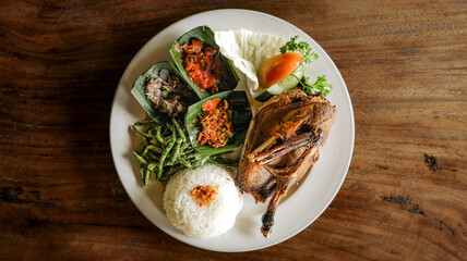 Delicious Balinese crispy fried duck from Bebek Tepi Sawah Restaurant, served golden brown with...