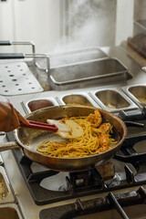 Shrimp Pasta Cooking in Pan on Stove