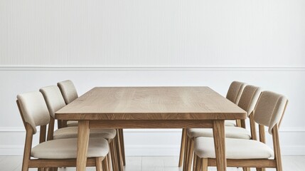 Modern wooden table with beige upholstered chairs on white background.